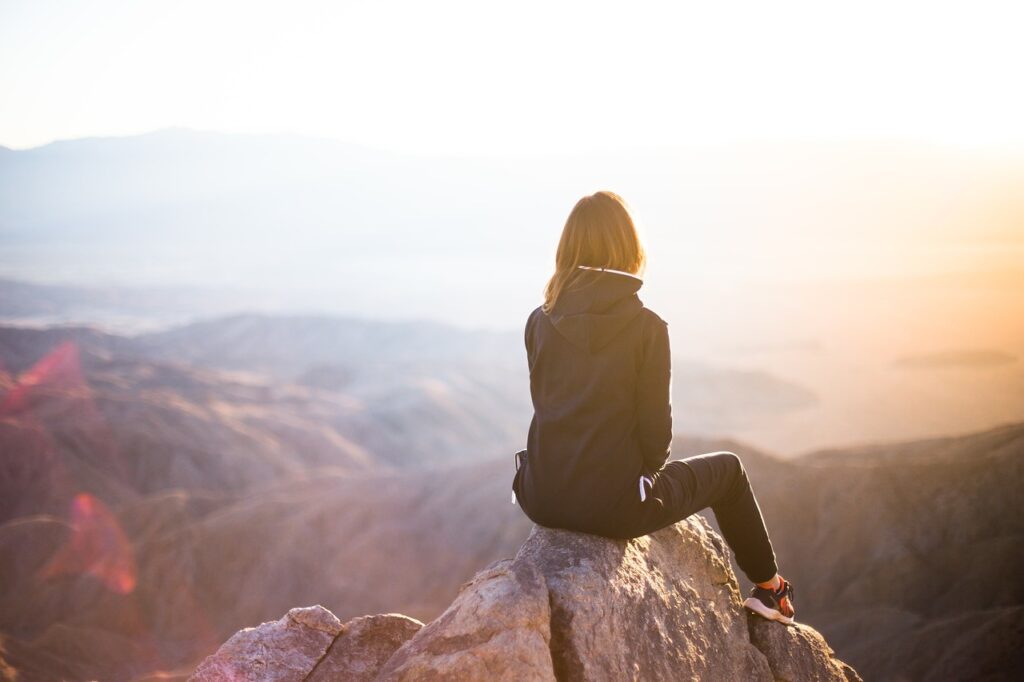 people, nature, woman, travel, adventure, trek, mountain, rock, sunset, cliff, black, hoodie, jacket, alone, thinking, freedom